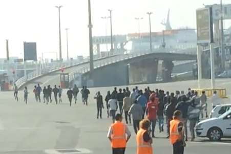 Officials look on as the illegal immigrants are taken away. Picture: Mark Salt