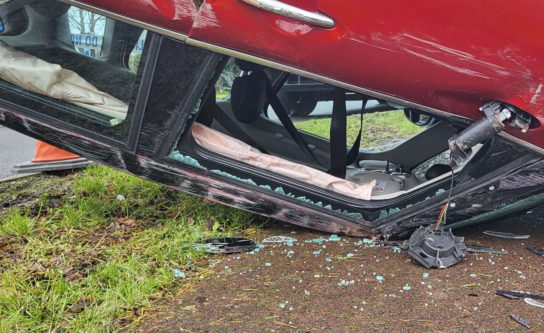 A red Mini Cooper crashed at the roundabout near the Old Gate Inn in New Dover Road, Canterbury