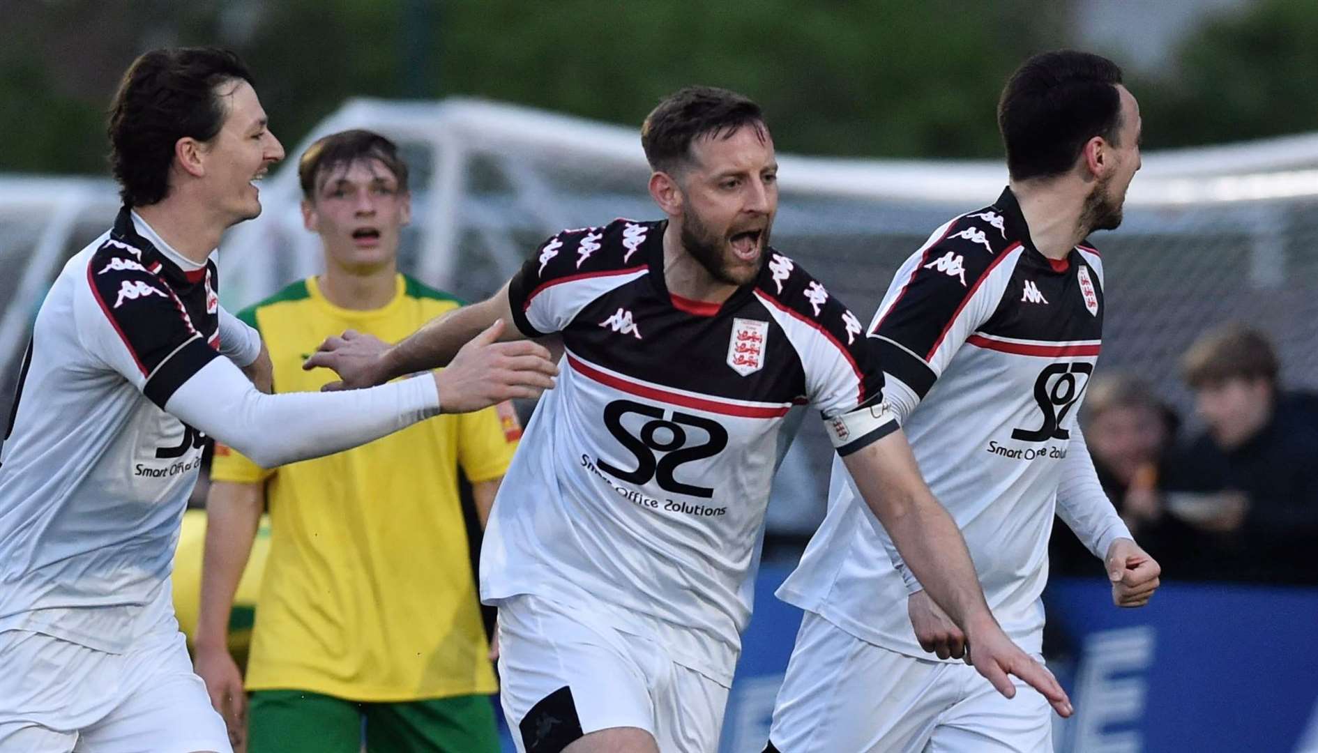 Faversham Town captain Connor Essam celebrates his goal with Billy Bennett and Ben Gorham. Picture: Ian Scammell