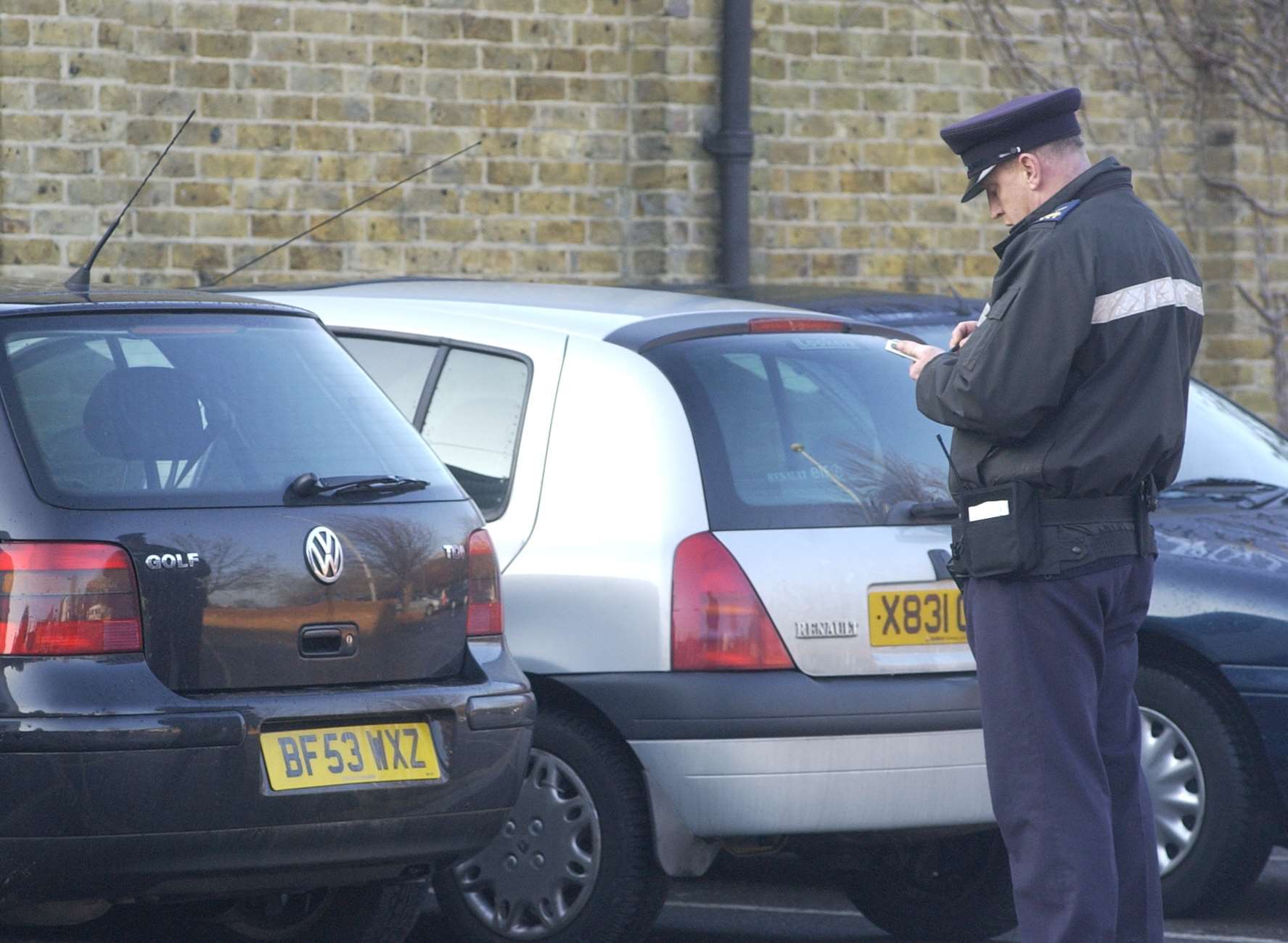 Traffic warden at work. Stock picture