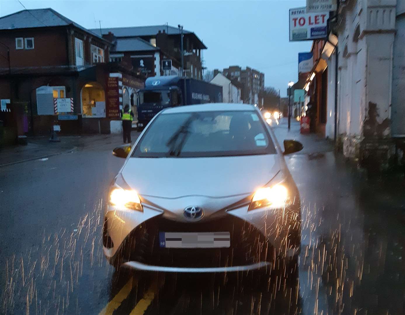 The parking warden's car was parked on double yellow lines in Maidstone, while the warden spoke to a lorry driver nearby