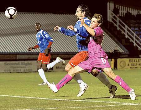 Ashley Miller and Andy Sambrook race to get to the ball first