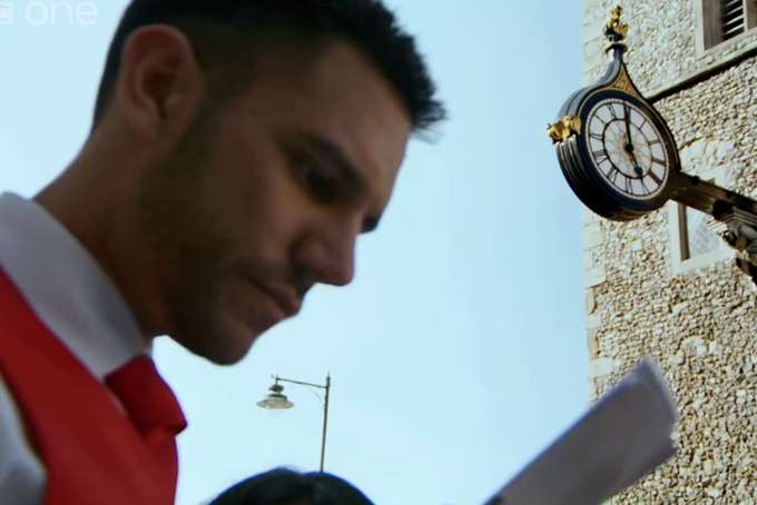 Sanjay consults a map as he gets lost near the St George's Tower in Canterbury