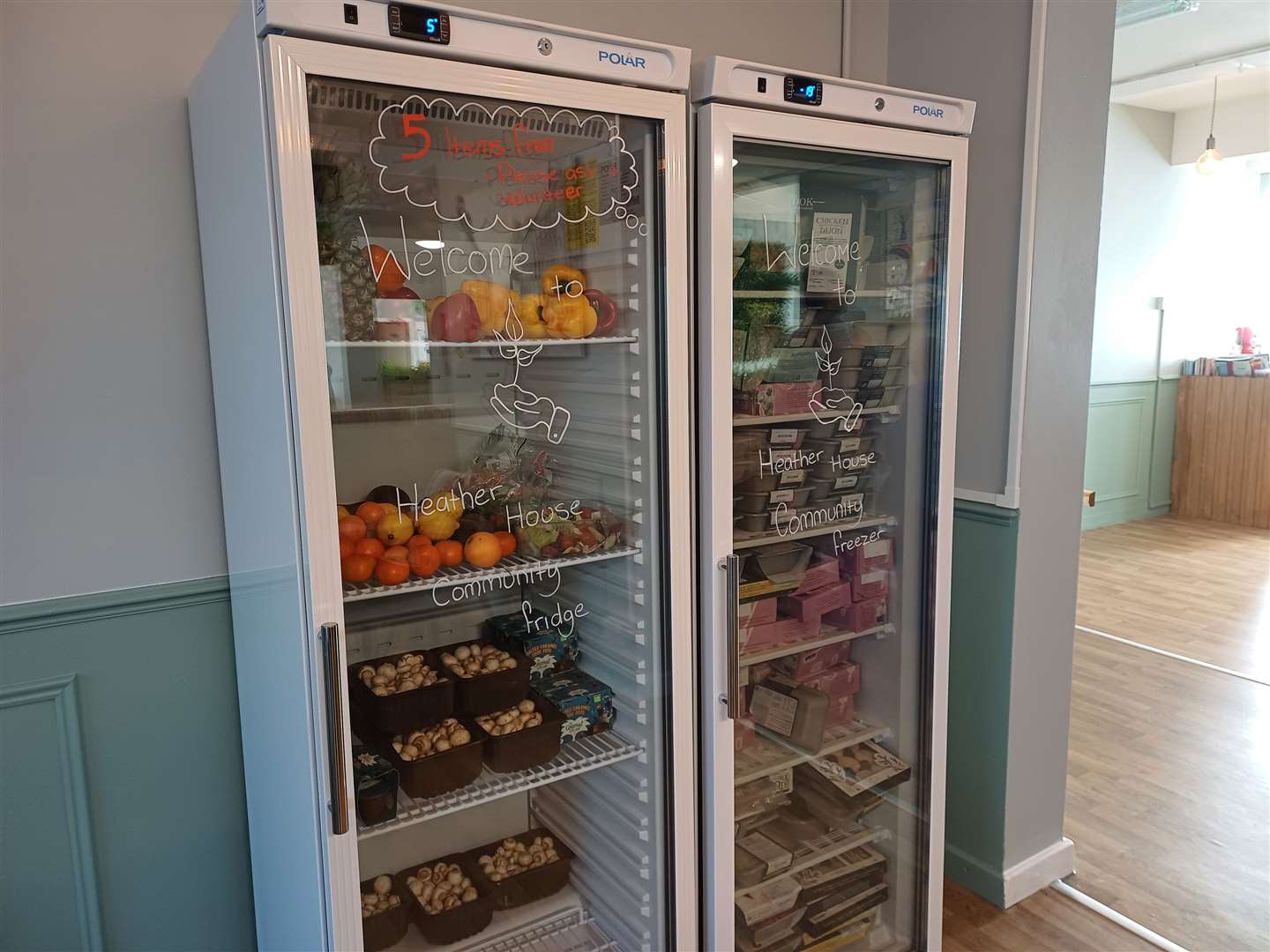 The community fridge is stocked full with fresh fruit, veg and meals