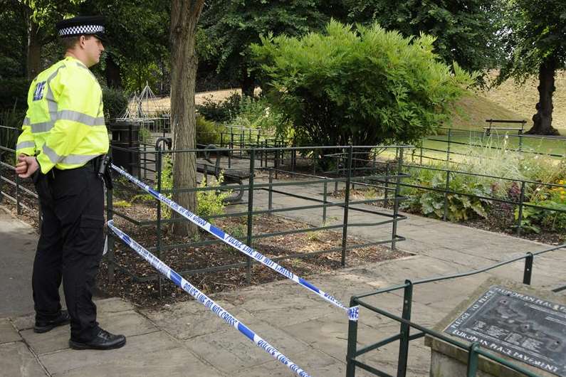 A policeman guards the scene in Dane John Gardens in Canterbury