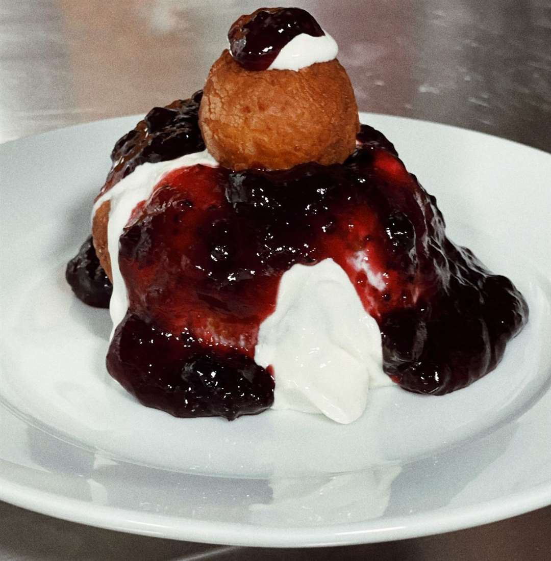 A Romanian cheese doughnut served with sour cream and jam. Picture: Vasile Conduraru