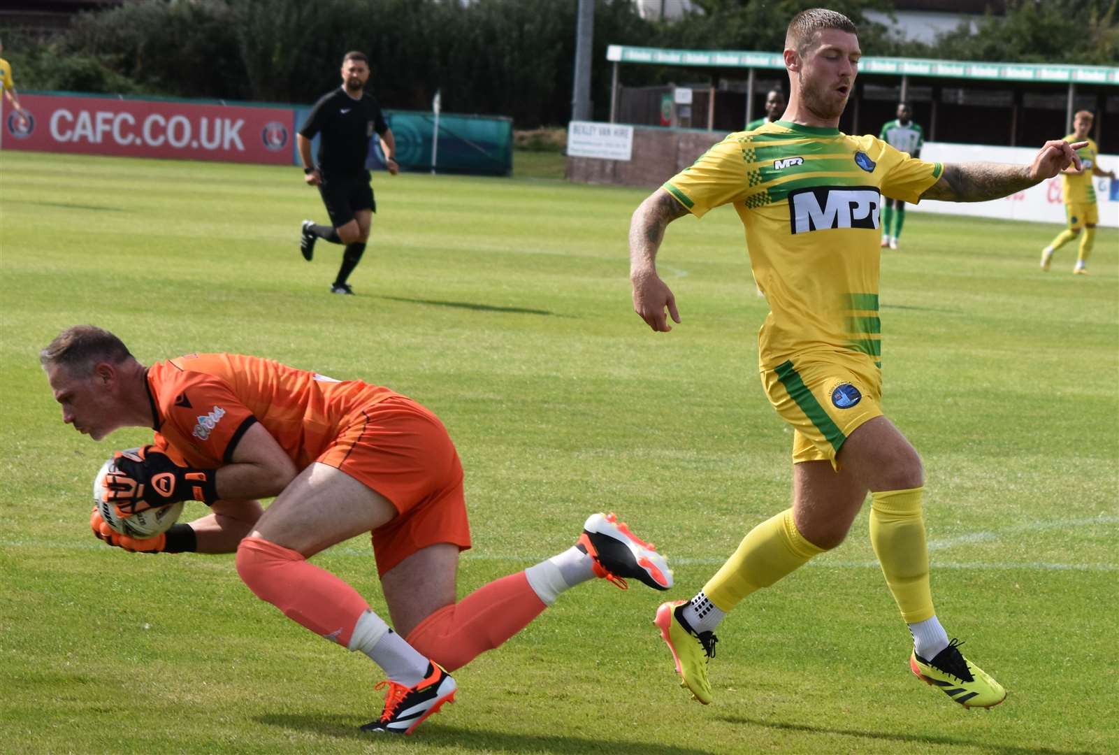 Lydd's Charlie Webster is foiled by veteran VCD keeper Andy Walker as the Vickers started their league campaign with a 1-0 weekend win. Picture: Alan Coomes