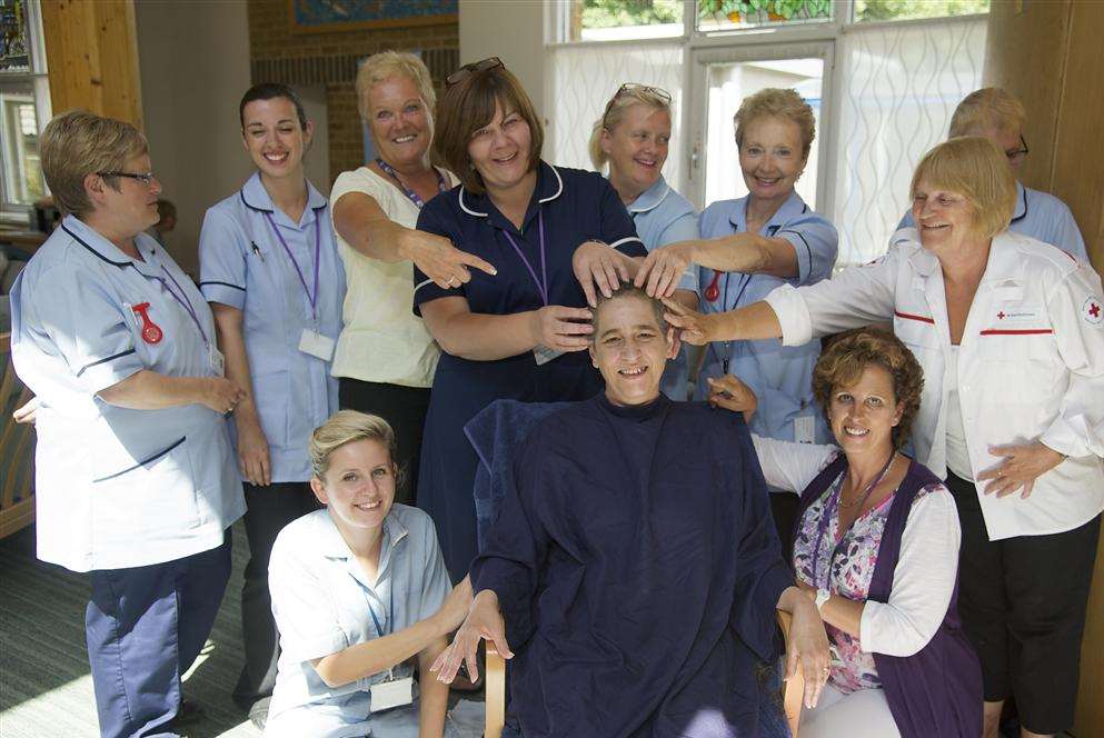 Palliative Care Nurse Lesley Dawson has her head shaved by Anita Moore at the Ellenor Lions Hospice