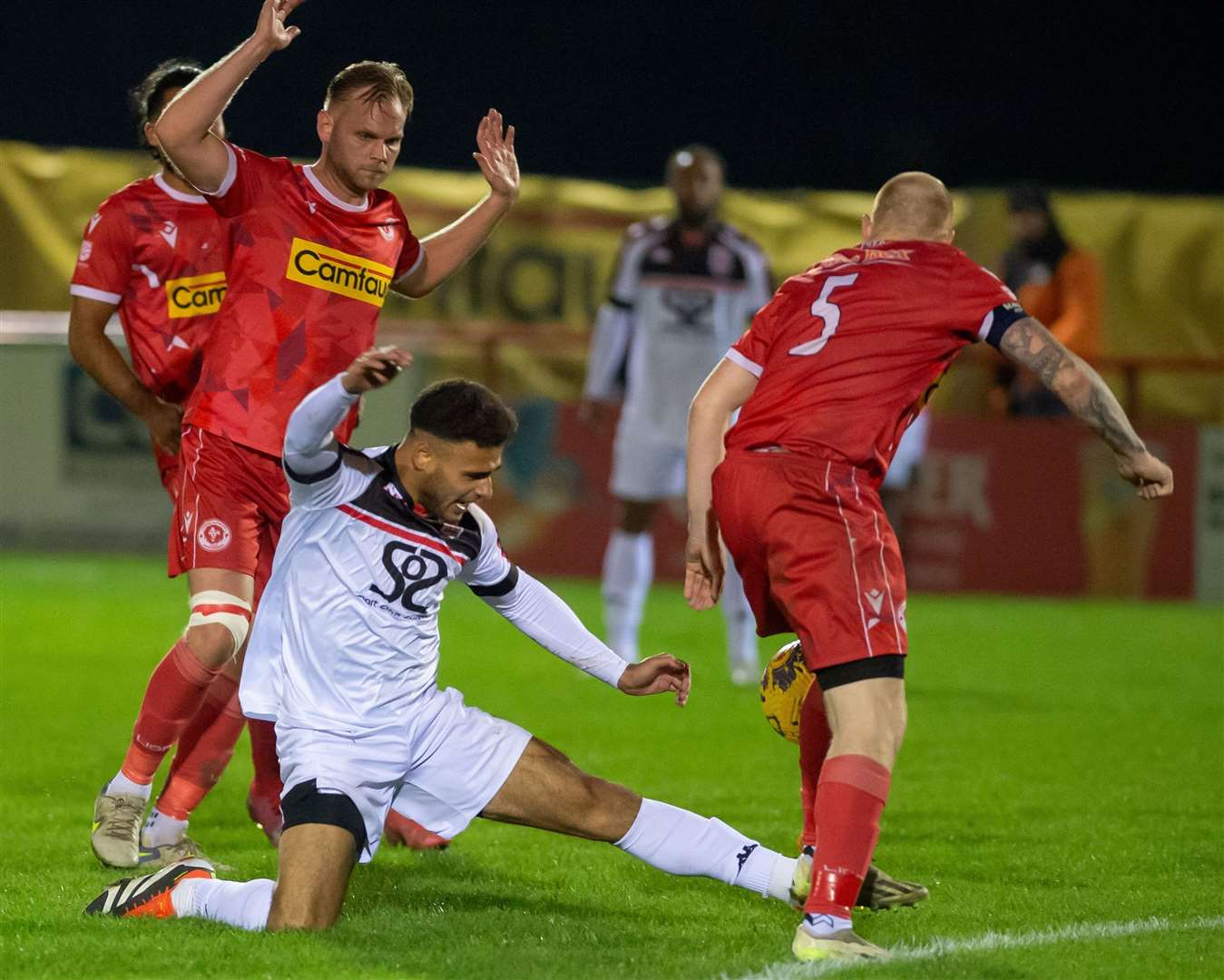 Returning Faversham midfielder Bradley Schafer puts his foot in against Punjab United captain Steve Ratcliff as the Lilywhites earned a 3-0 victory last Friday night. Picture: Ian Scammell