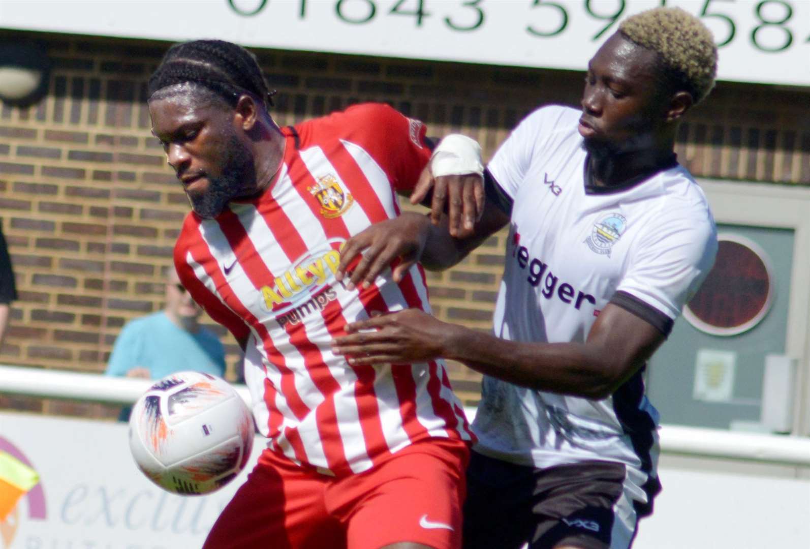 David Smith, of Folkestone, tussles for the ball amid their weekend friendly 2-1 loss at Dover. Picture: Randolph File