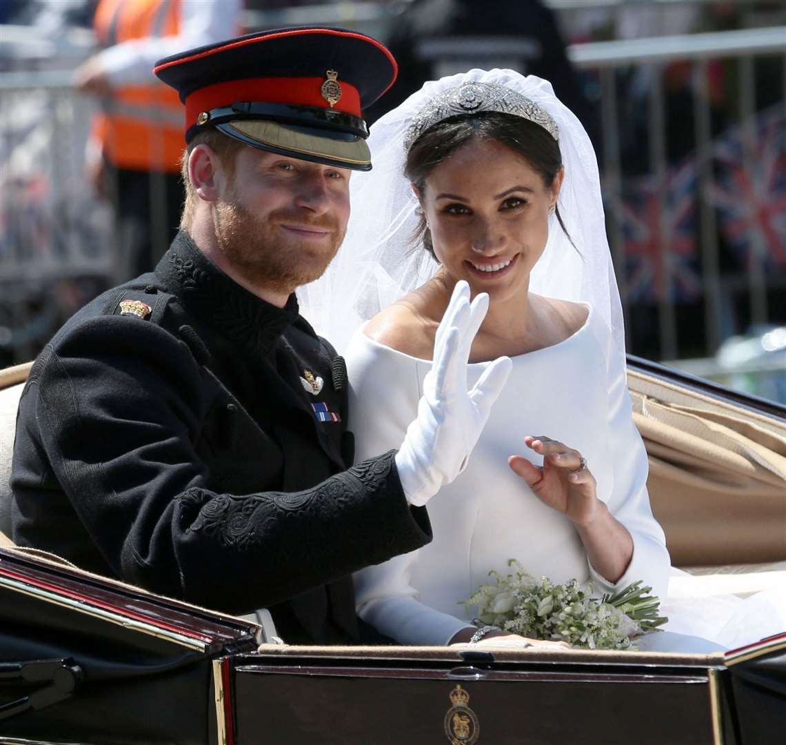 Prince Harry and Meghan Markle ride through Windsor following their wedding in 2018. Picture: Aaron Chown/PA Wire