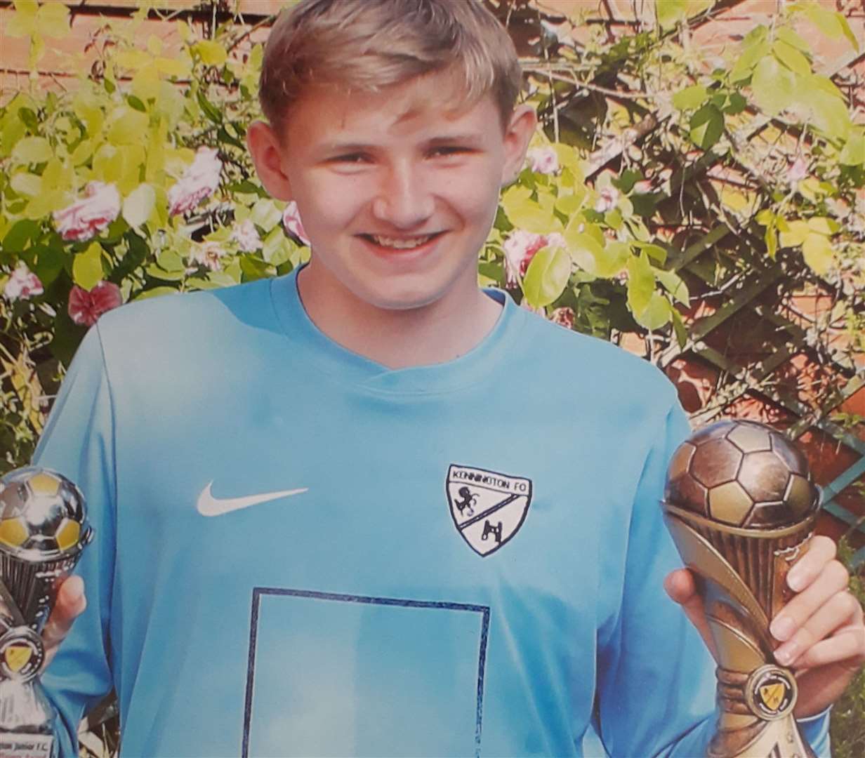 Owen Kinghorn pictured two years ago holding a player's trophy and the award for being the manager's player of the year