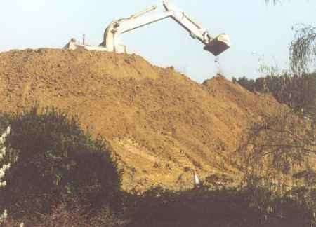 An earthmover building the mound at St Mary's Platt - just yards away from residents' back gardens