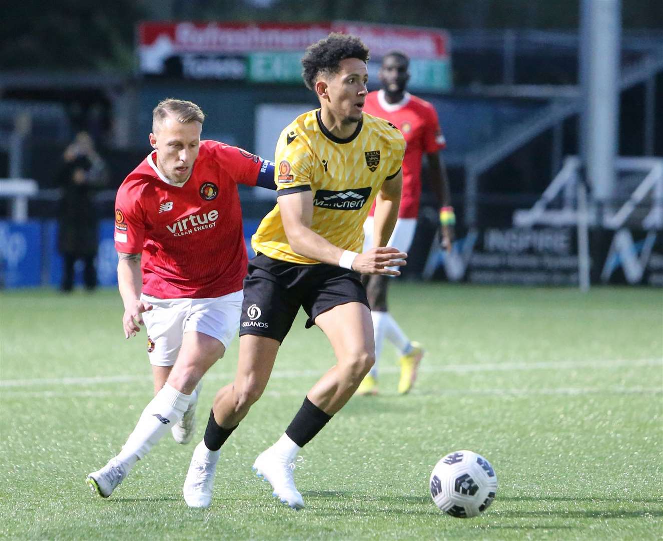 Sol Wanjau-Smith, scorer of Maidstone's seconds, shields the ball from Fleet captain Chris Solly. Picture: PSP Images