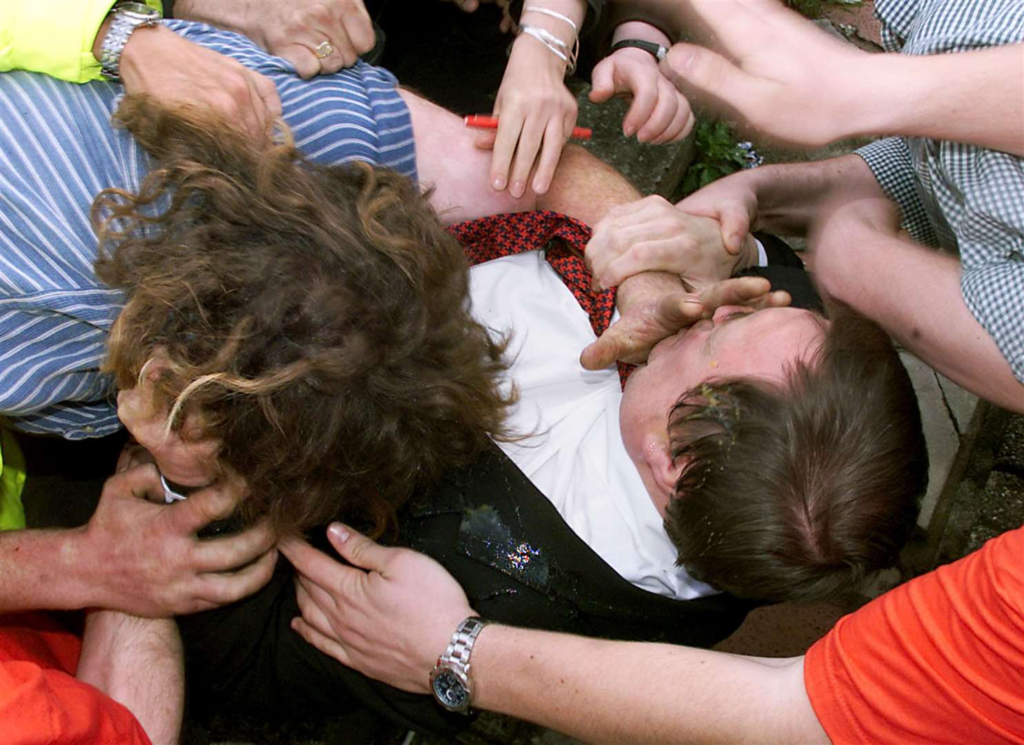 John Prescott being hit by an egg while surrounded by protesters in the seaside resort of Rhyl (David Kendall/PA)