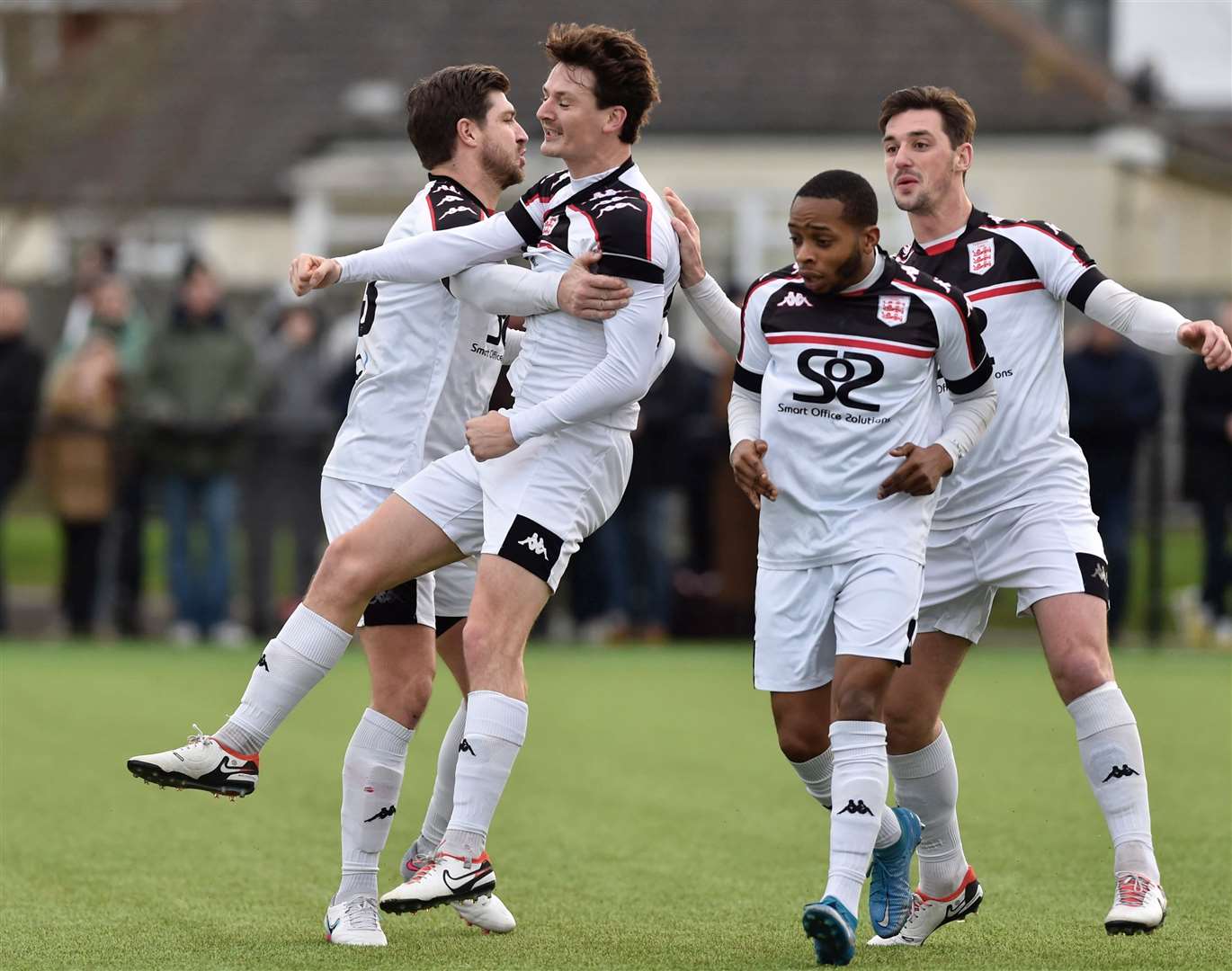 Billy Bennett celebrates giving Faversham the lead with team-mates Matt Newman, Sam Hasler and Kieron Campbell. Picture: Ian Scammell