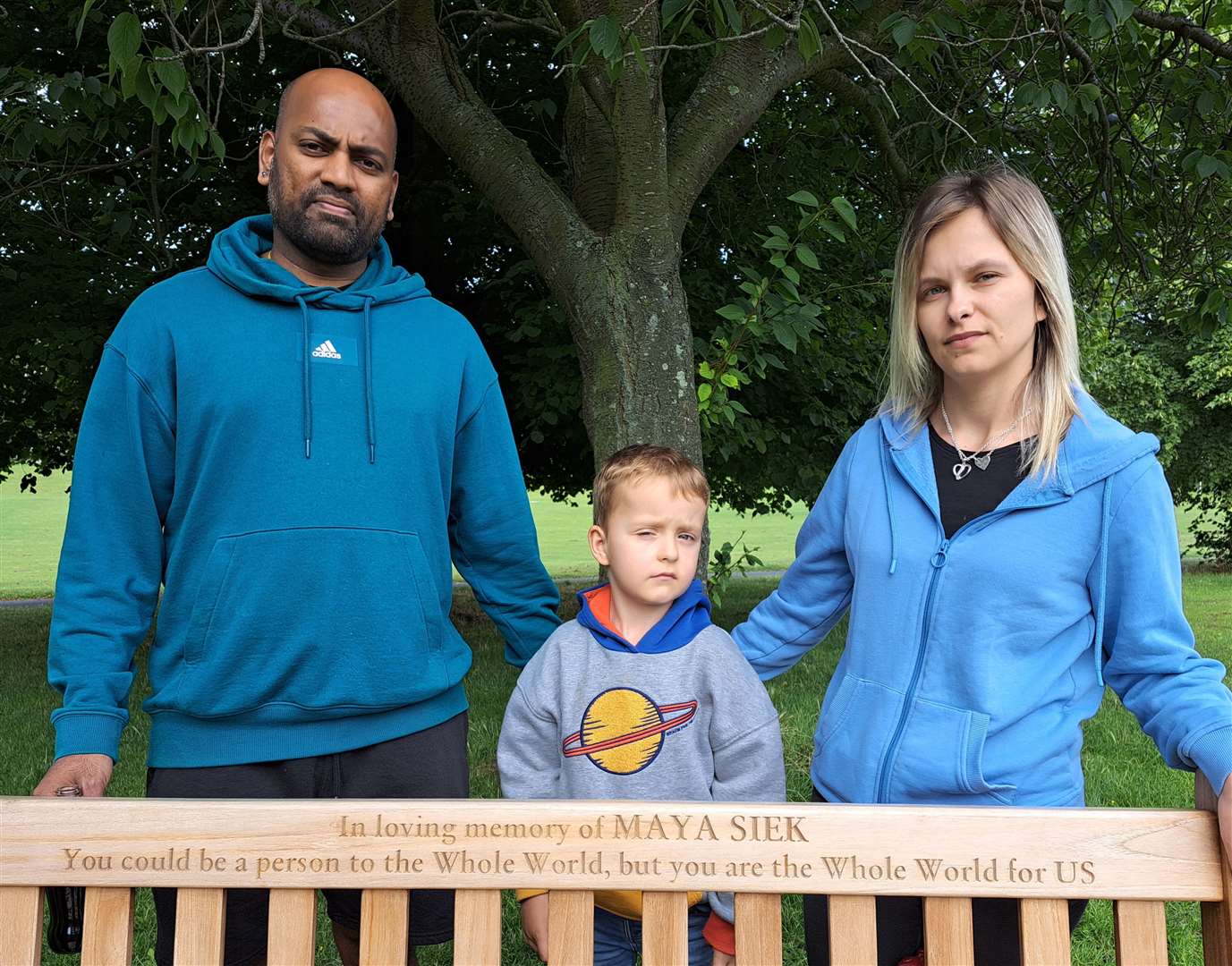 Rajratan Bande, Magdalena Wisniewska and their son Nathan with the bench dedicated to Maya