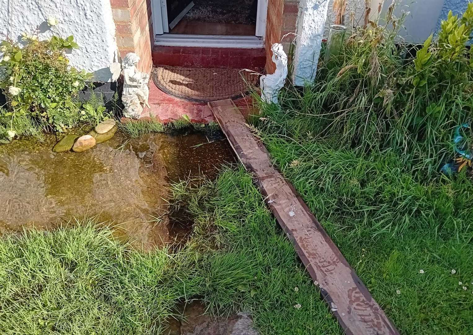 Ms Storey has to walk across a plank when the water is deep. Picture: Vikki Storey