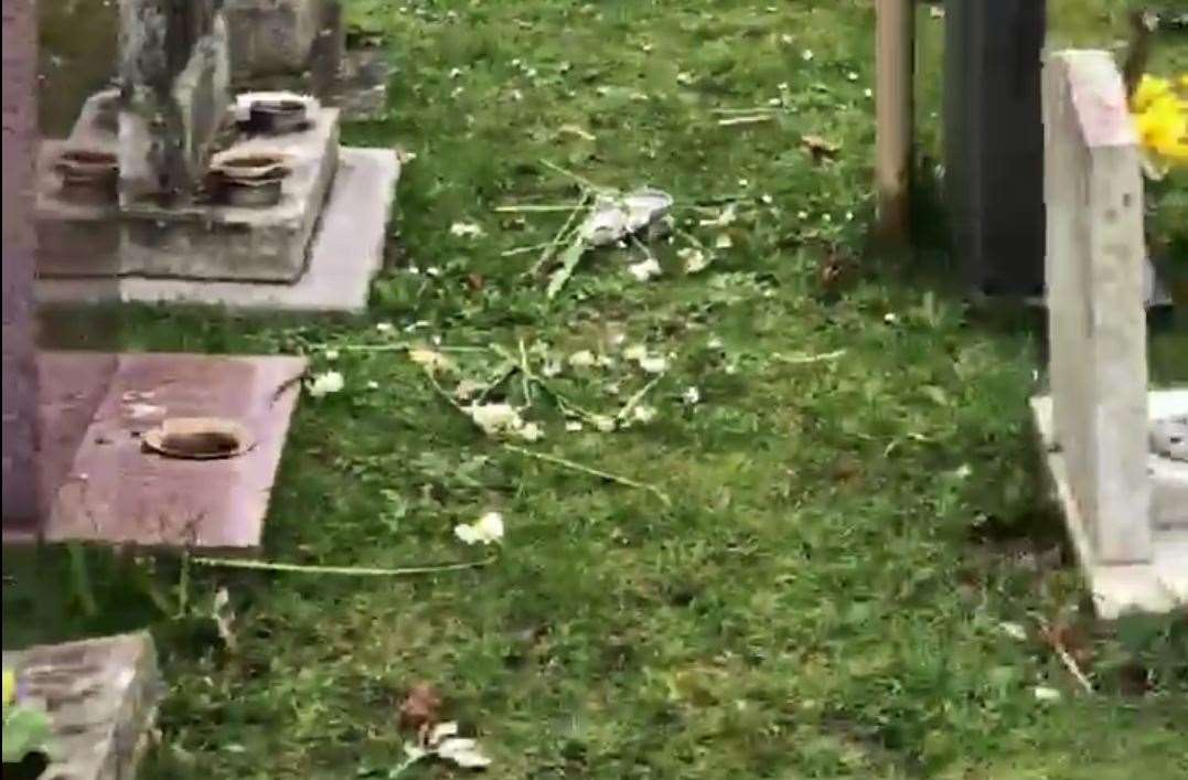 Flowers and memorials strewn across the grass at St John's cemetery in Margate (8334747)