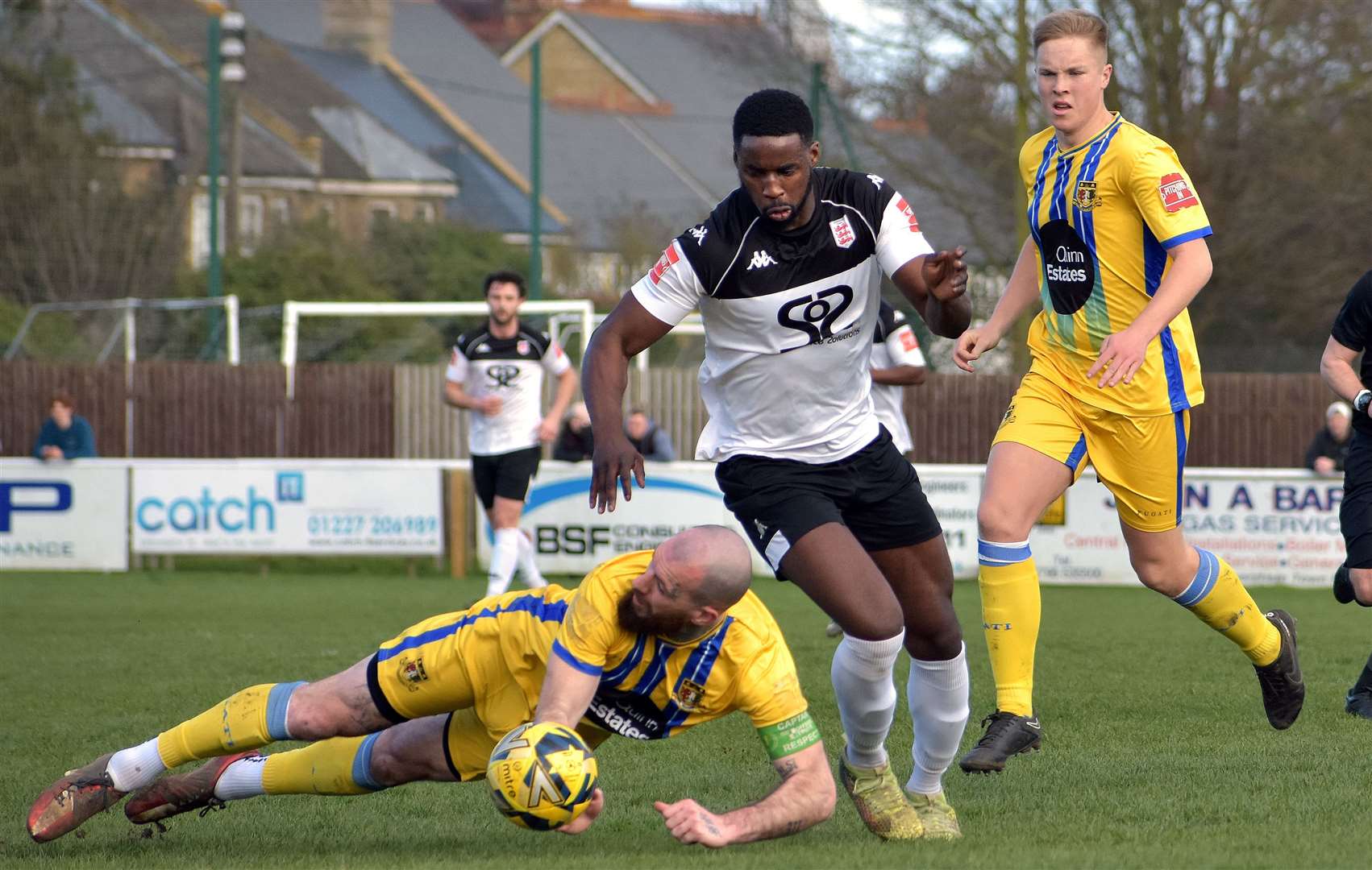 Sittingbourne skipper Joe Ellul is booked for bringing down Town frontman Shola Ayoola. Picture: Randolph File