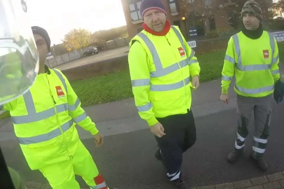 The refuse collectors pulled over to check on the rider