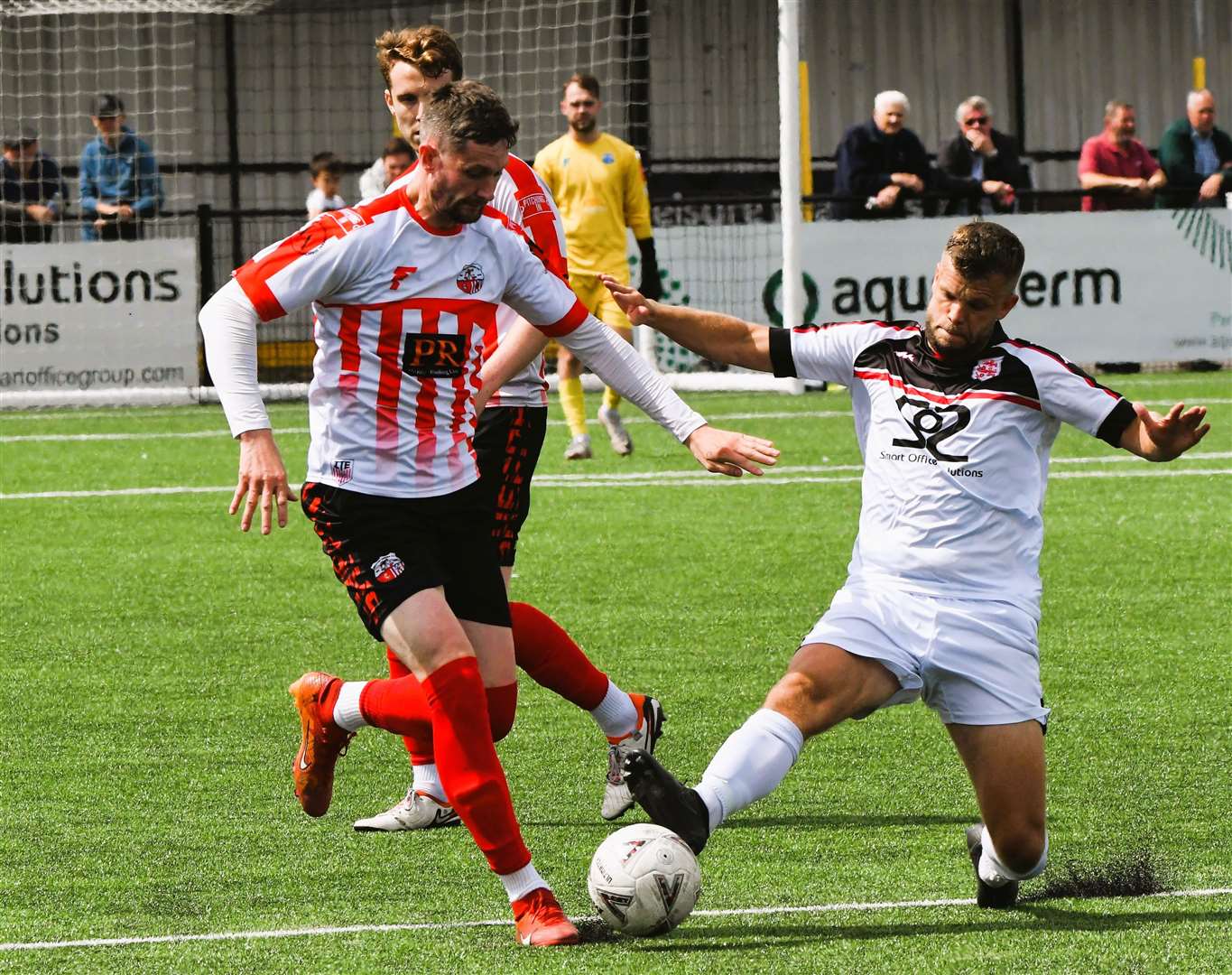 Sheppey striker Dan Bradshaw up against Faversham's Henry Muggeridge. Picture: Marc Richards