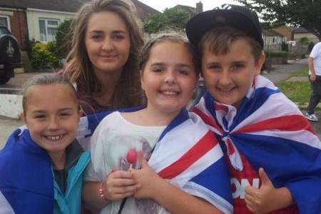 Children wait for the Olympic torch in Sturry Road