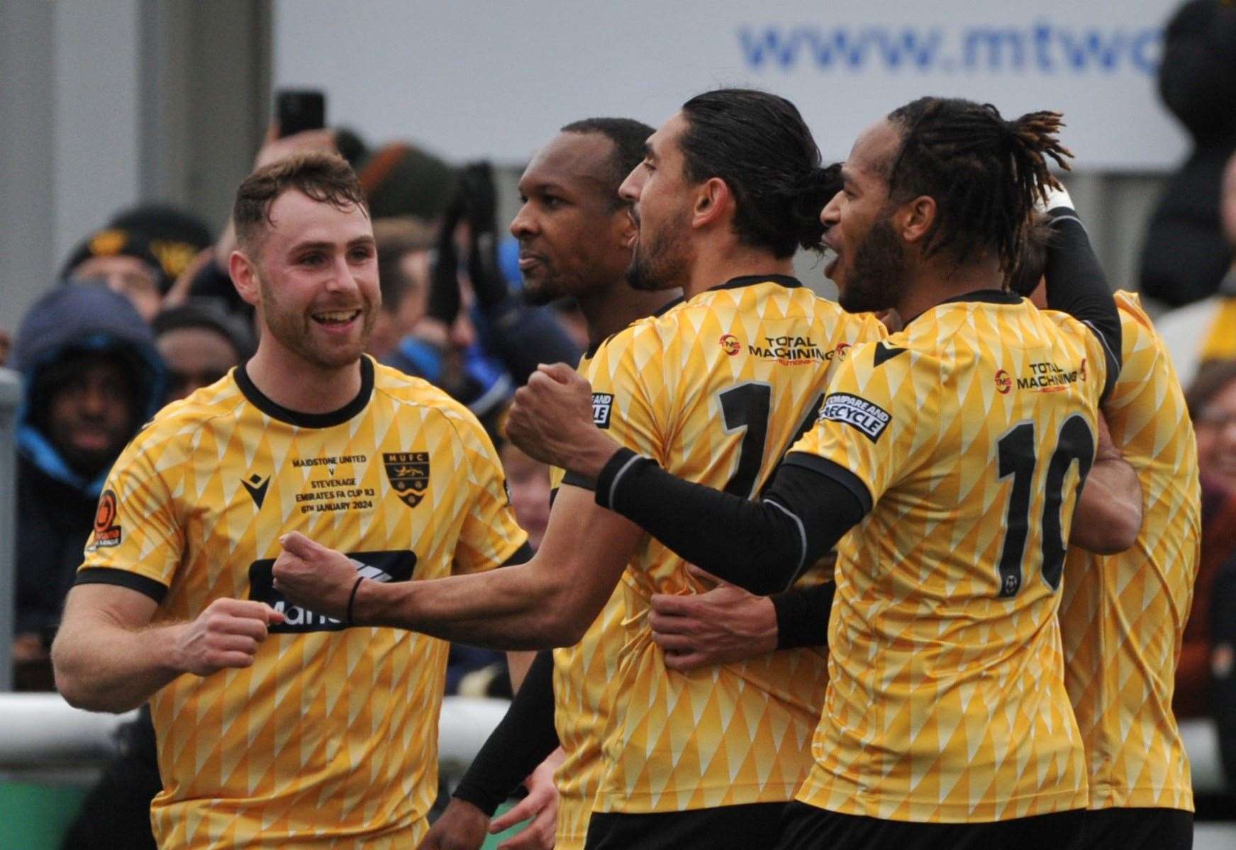 George Fowler, left, joins the celebrations after Sam Corne's penalty. Picture: Steve Terrell