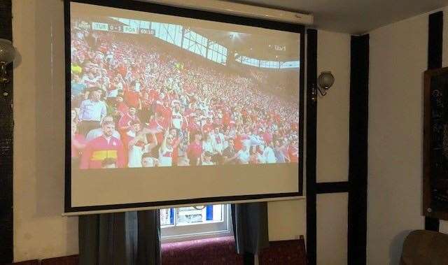 There was no-one in to see it but the projector screen at the rear of the pub was showing football