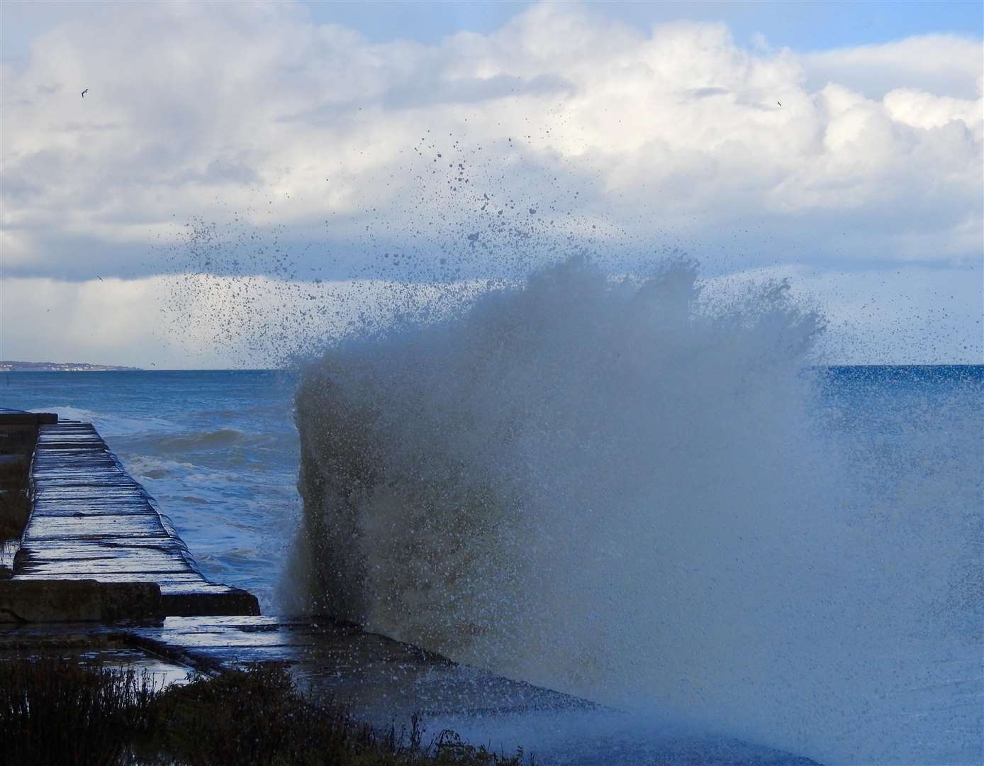 Fierce waves crash over the edge of a wall at Kingsdown Rifle Range Picture: Dean Macey