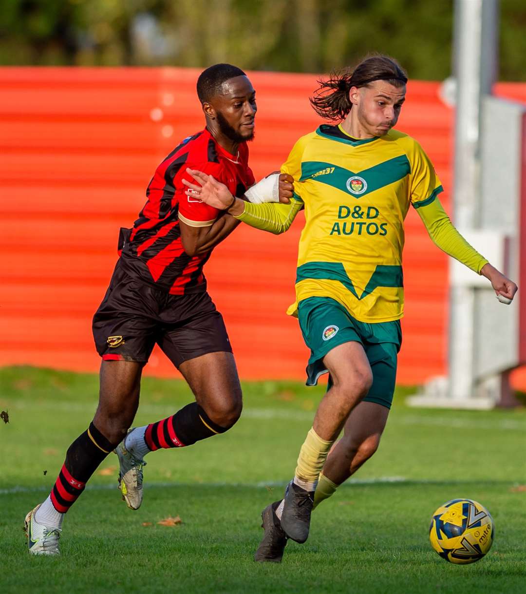 Frank Puemo tries to stop Ashford striker George Nikaj in his tracks. Picture: Ian Scammell