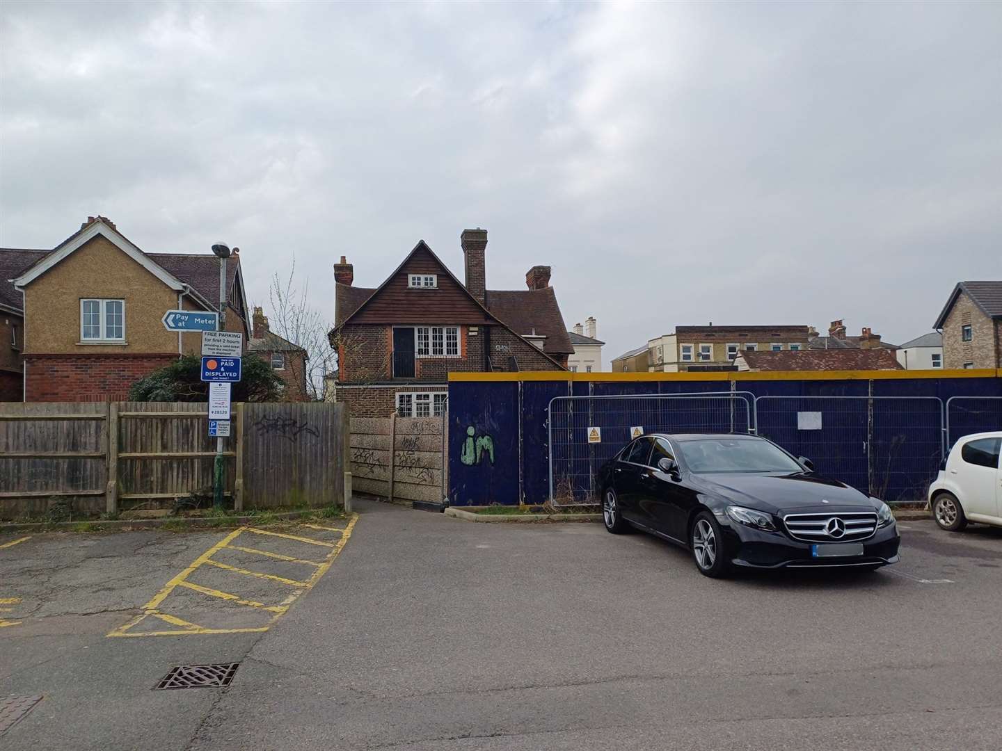 The "fake" space, where the Mercedes-Benz sits, is between a disabled bay and another parking space