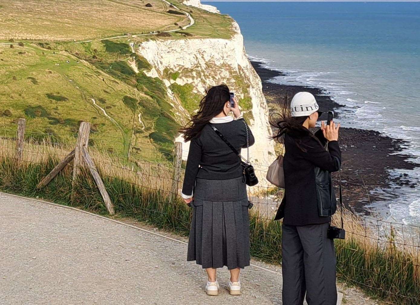 Tourists taking photographs at the Langdon part of the White Cliffs of Dover