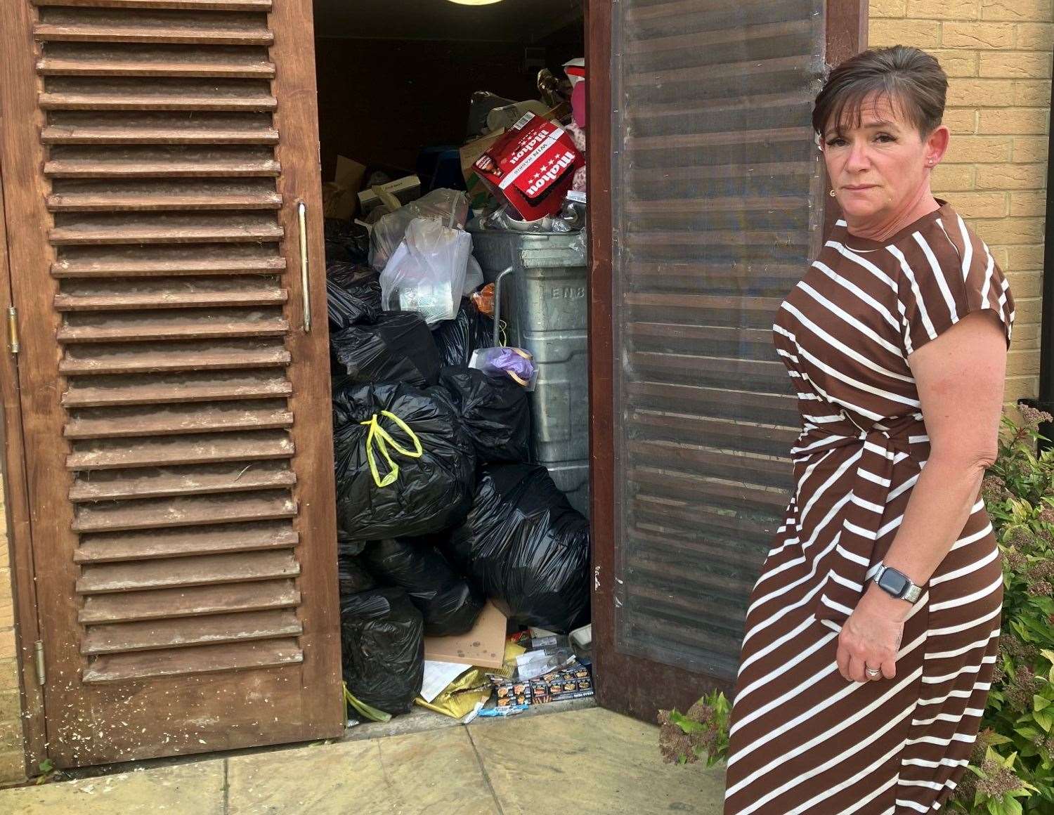 Sarah Barnes with the rubbish by her daughter's flat at Hedley Walk, Church Street, in Sittingbourne. Picture: Sarah Barnes