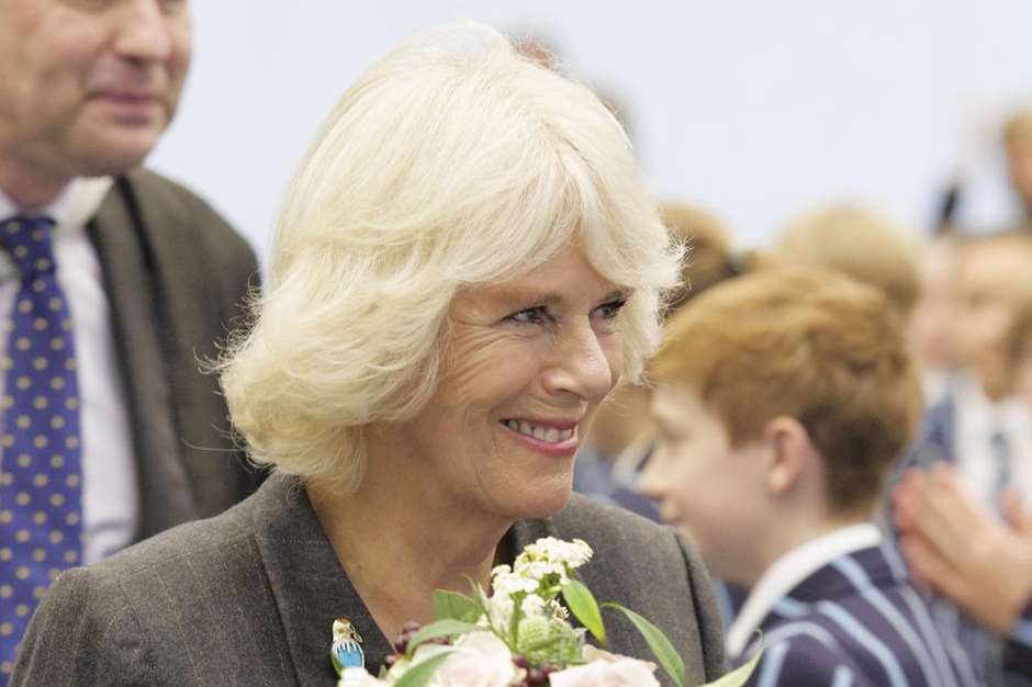 The Duchess leaves the school sports hall with her flowers