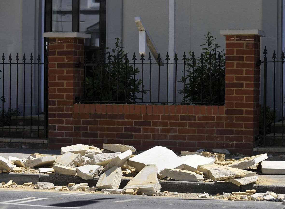 Rubble is seen in the street in Roper Road, Canterbury