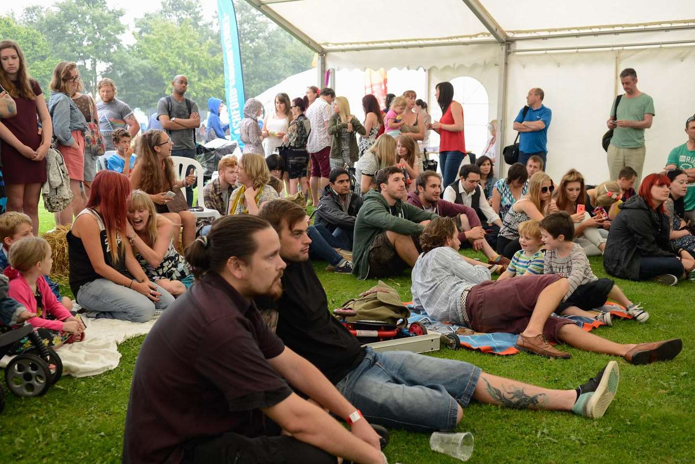 Crowds took cover at the Other stage when the rain came