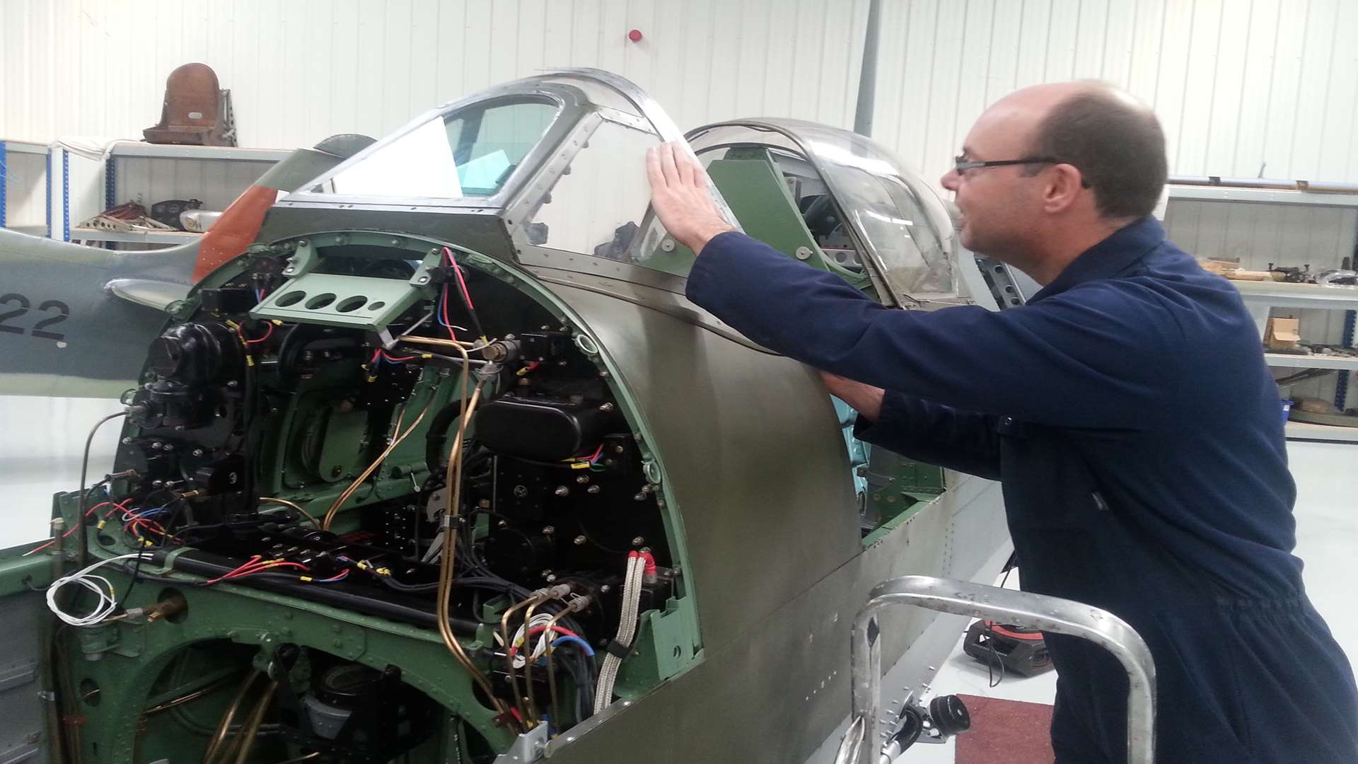 Dick Sanders works on one of the planes at Biggin Hill