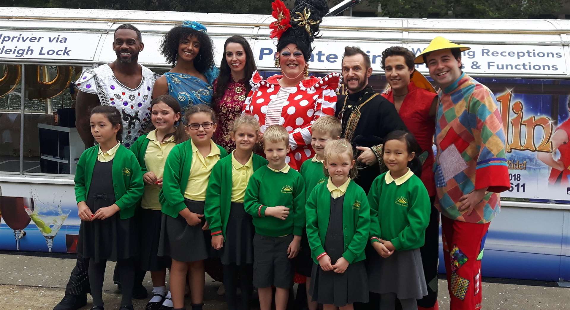 Actors line up with children from East Borough Primary school who were treated to a boat ride