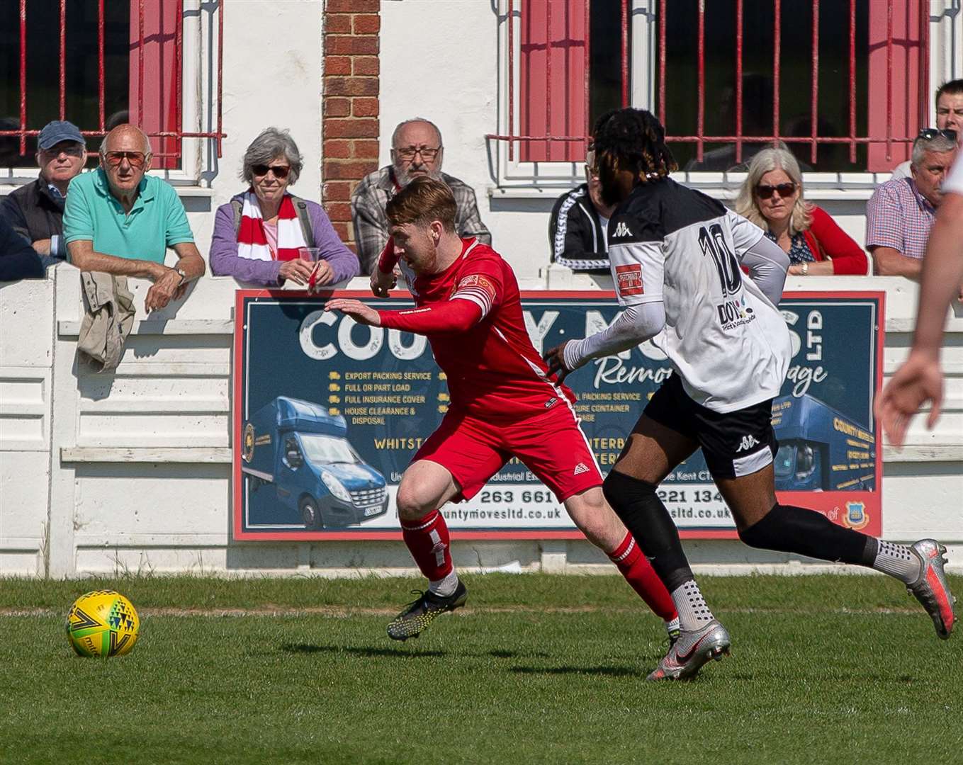 Jake Mackenzie is closed down by Emmanuel Oluwasemo as Whitstable faced Faversham, last season Picture: Les Biggs