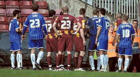 Players from both sides surround the linesman and referee to argue about the second goal, which was finally allowed to make the score 2-2