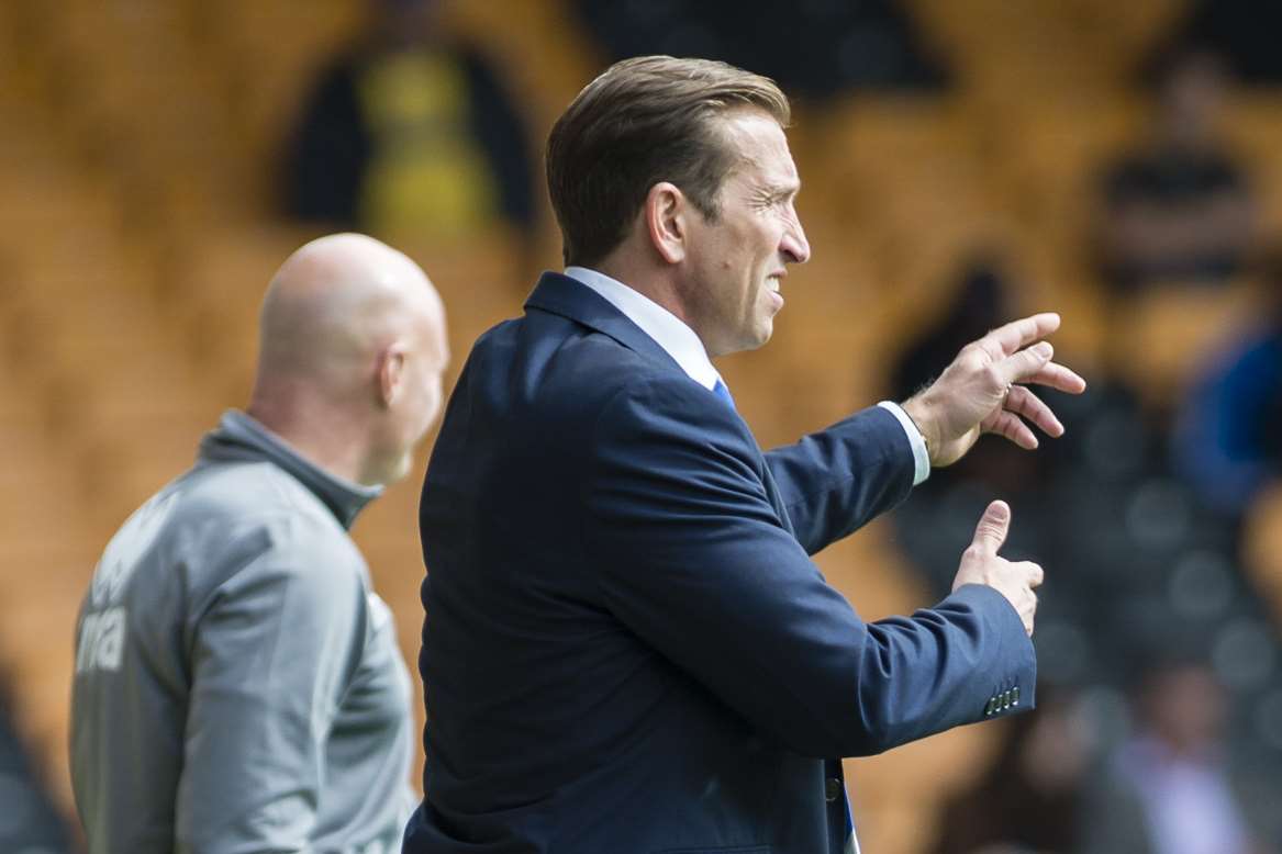 Gills boss Justin Edinburgh shouts encouragement from the sidelines Picture: Andy Payton