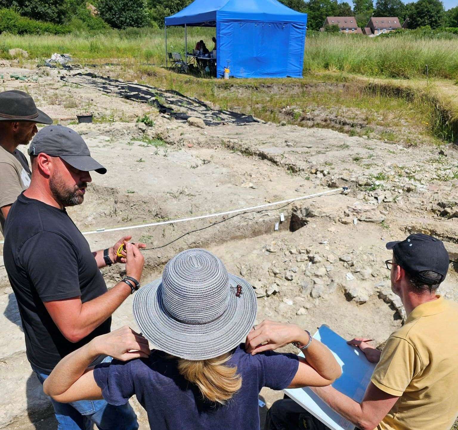 Richard Taylor, left, teaching archeologists new skills