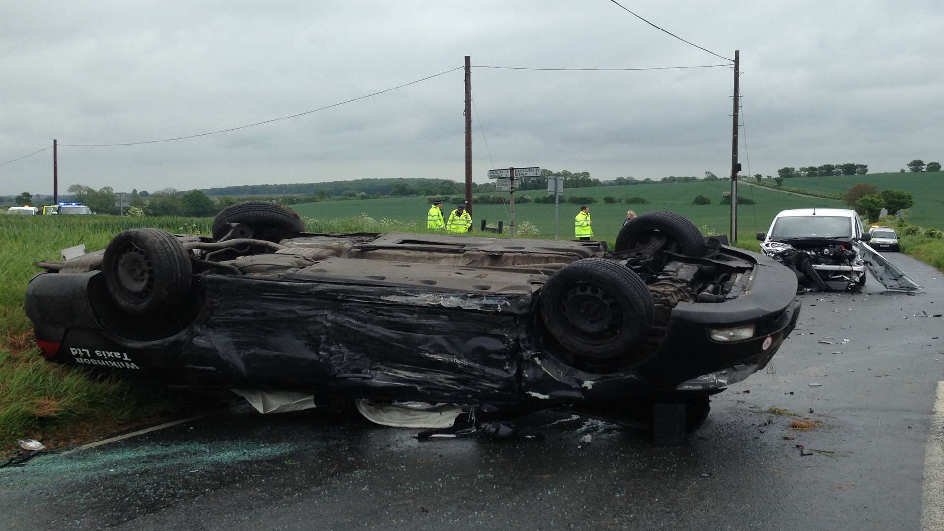 The taxi involved in this morning's accident was flipped on to its roof.