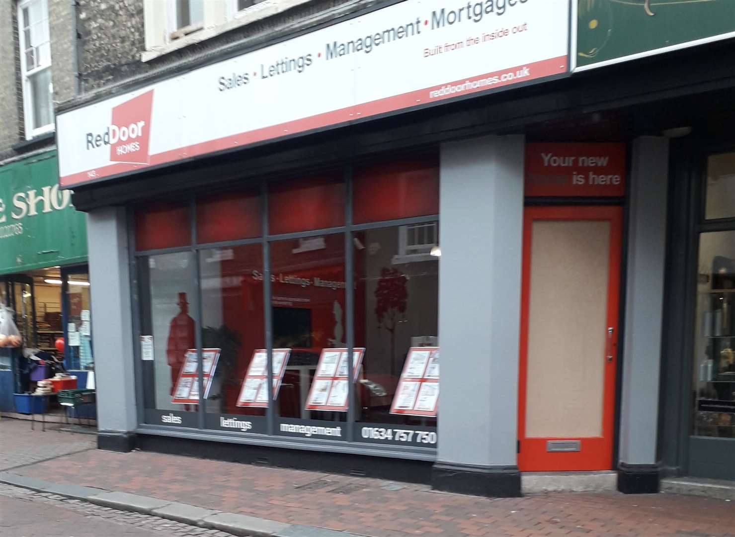 The boarded-up door at the estate agents