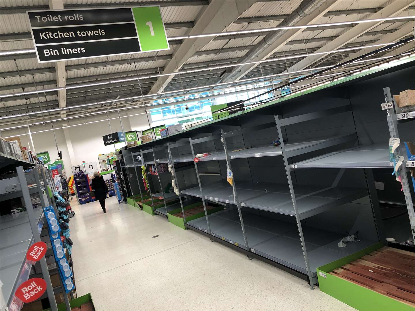 A view of empty shelves as toilet roll and kitchen roll are almost sold out in an Asda supermarket in Bearsden, East Dunbartonshire (Andrew Milligan/PA)