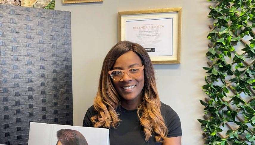 Belinda Gyampa, behind the desk of her salon, Belinda's Hair And Beauty Academy