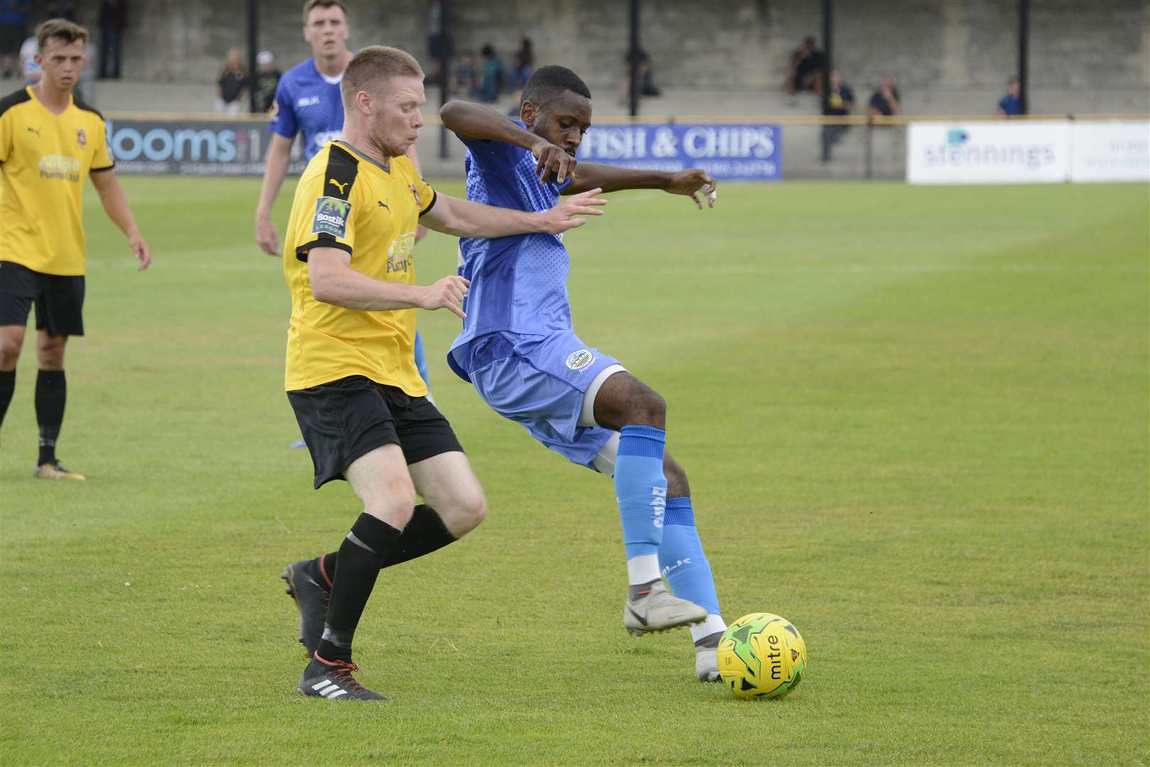 Dover's Kurtis Cumberbatch holds off Folkestone's Scott Heard. Picture: Paul Amos