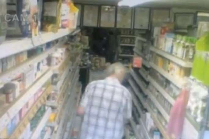 The man examines a box that has fallen to the floor - oblivious to another product that appears to be hovering