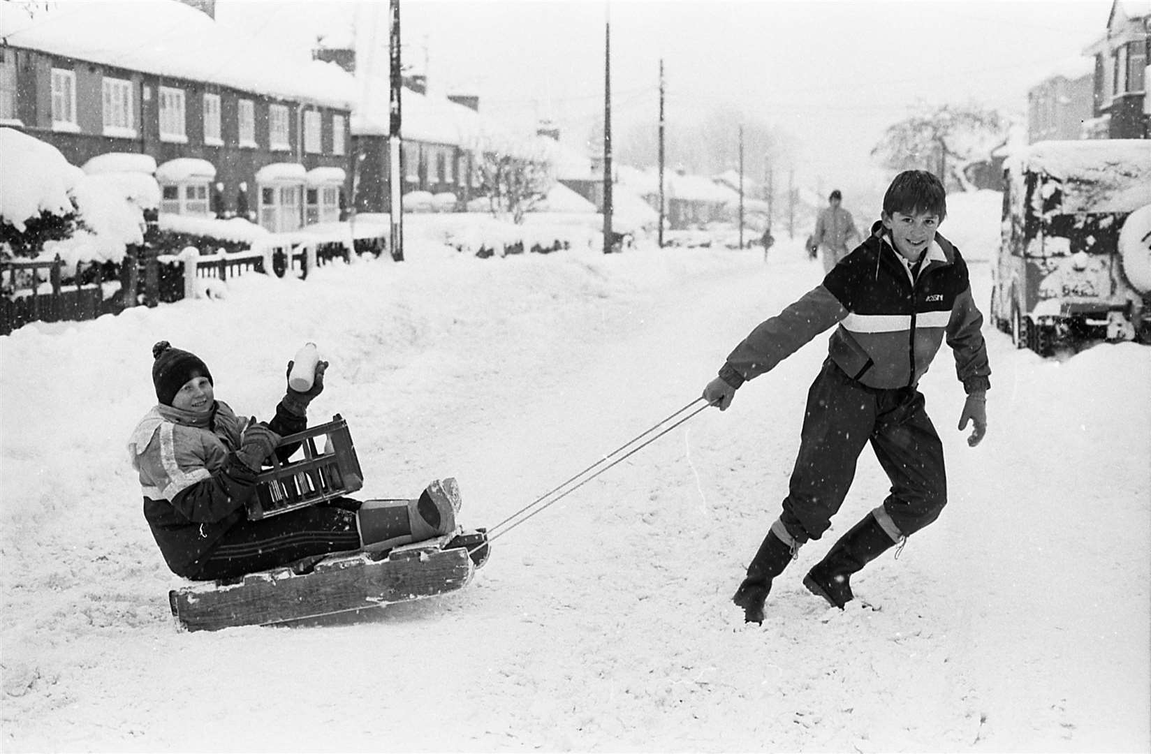 Boys celebrate as they make their way home with a bottle of milk from the local shop. Picture: Barry Hollis